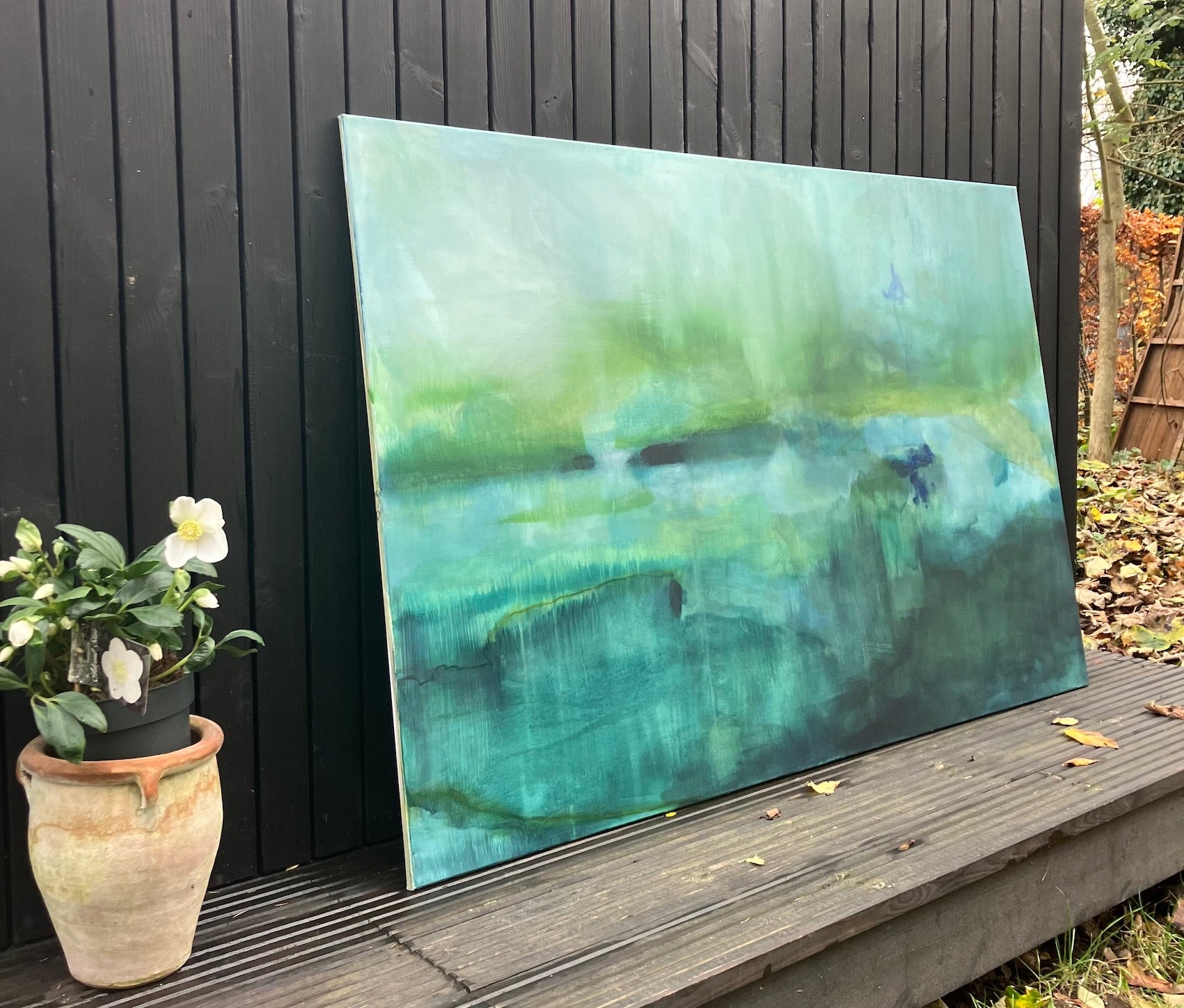 large green abstract landscape painting outside studio