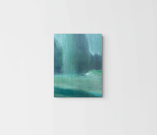 A vertical canvas print featuring an abstract landscape painting in shades of teal, green, and blue, displayed against a clean white wall.